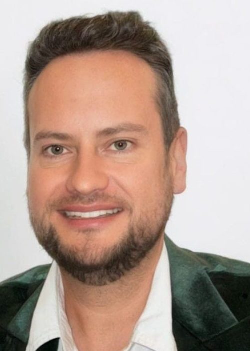 Bevan Fellow Dr Stuart Kyle wearing dark green velvet jacket and white shirt
